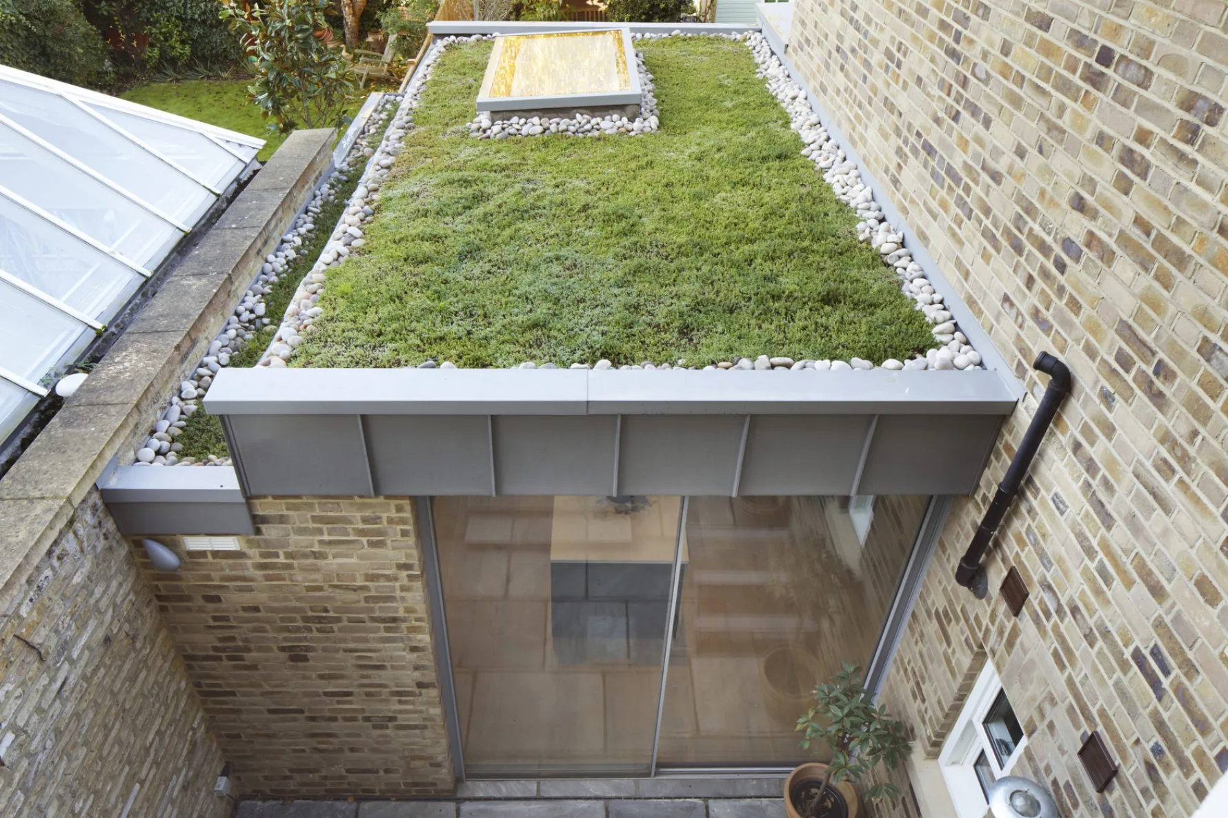 Sedum green roof with rooflight and zinc edging on the rear extension at Cleveland Road