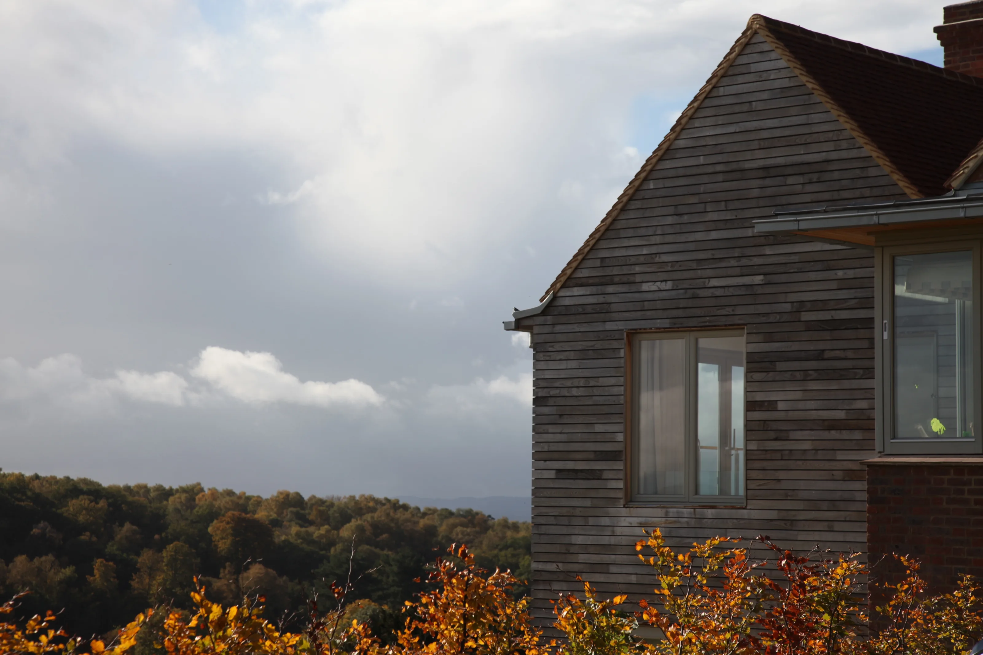 Timber-clad gable of Guildford House overlooking the surrounding Surrey Hills landscape.