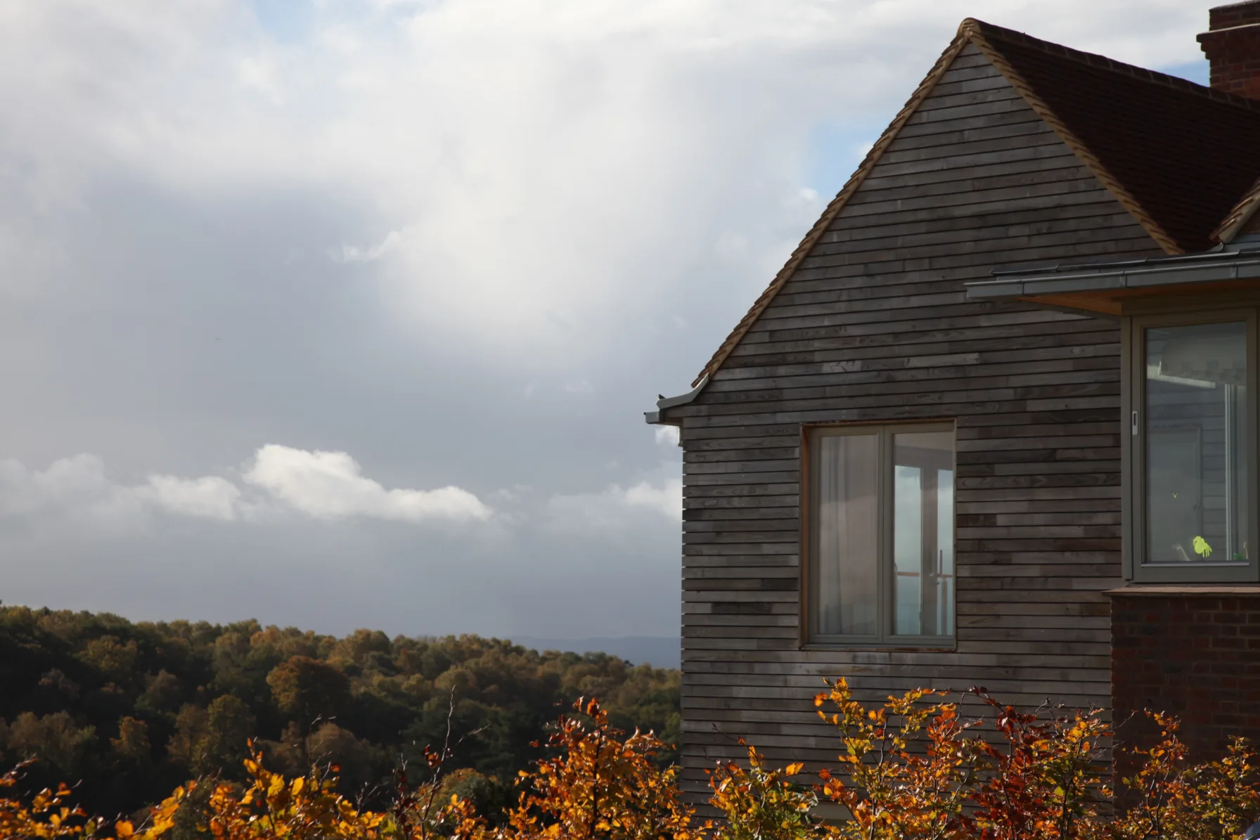Timber-clad gable of Guildford House overlooking the surrounding Surrey Hills landscape.