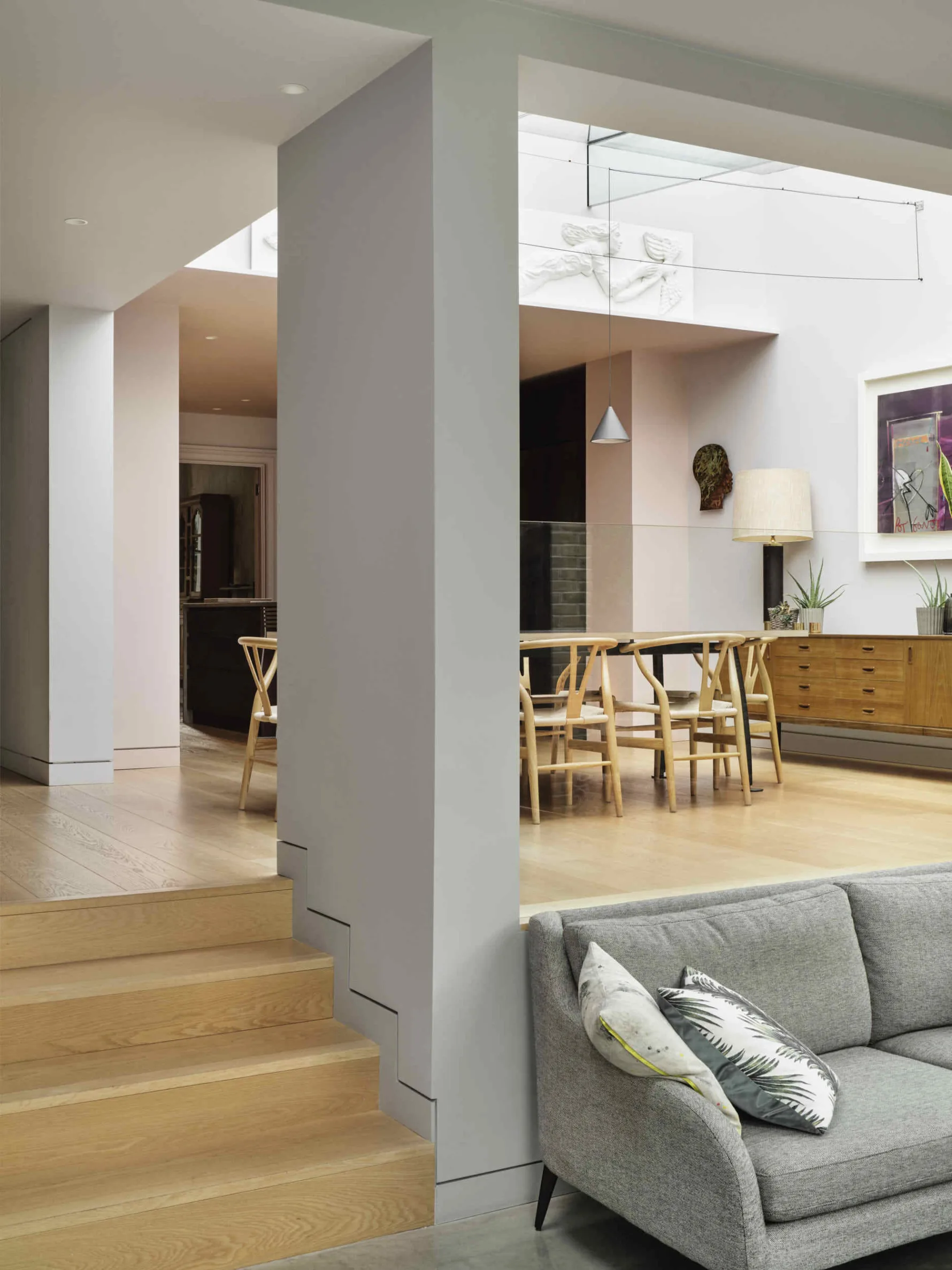 Split-level living space within the Kew House extension, connecting the dining area, garden room and original Victorian house