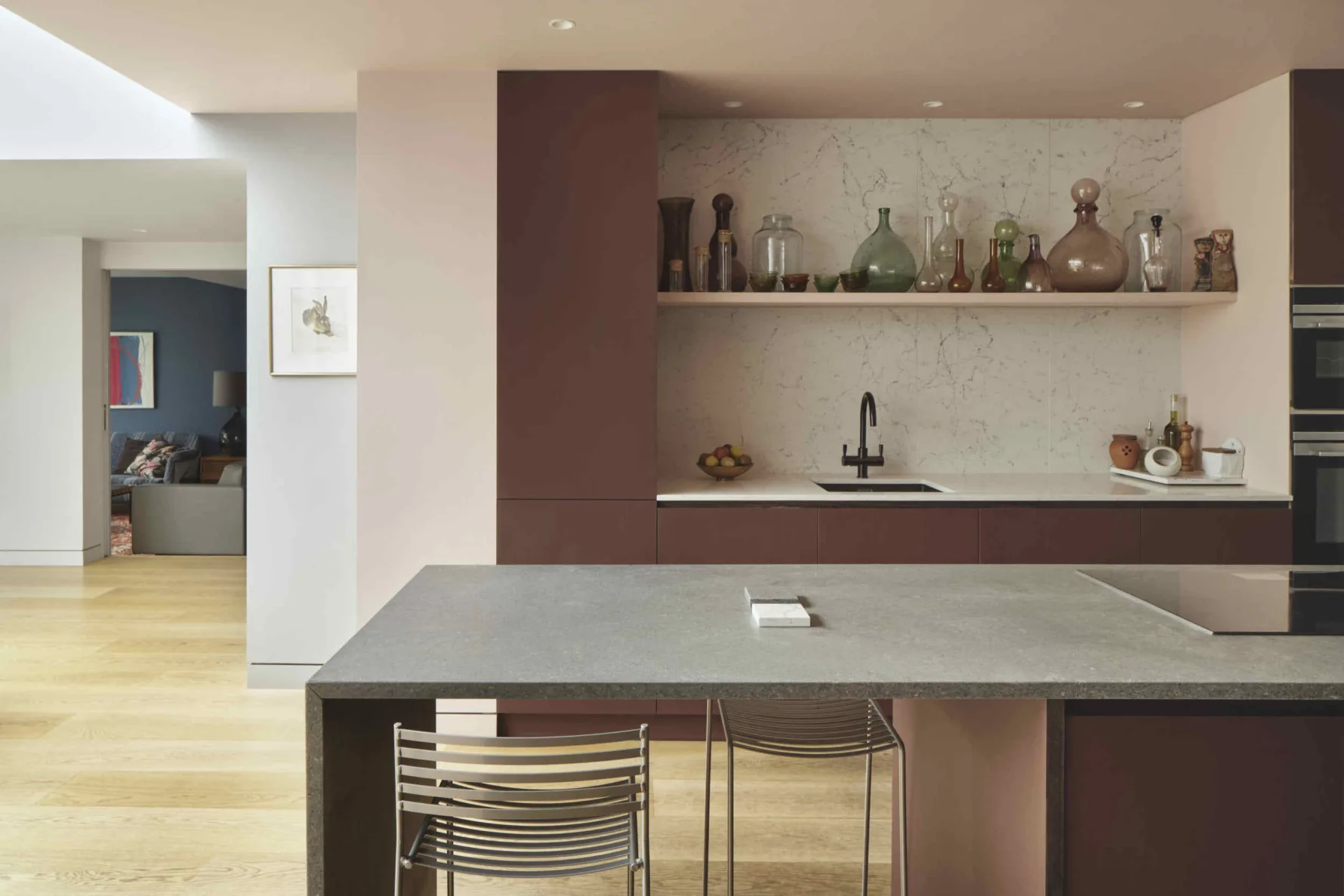 Contemporary kitchen within the Kew House extension featuring a stone island, bespoke cabinetry and open-plan living spaces