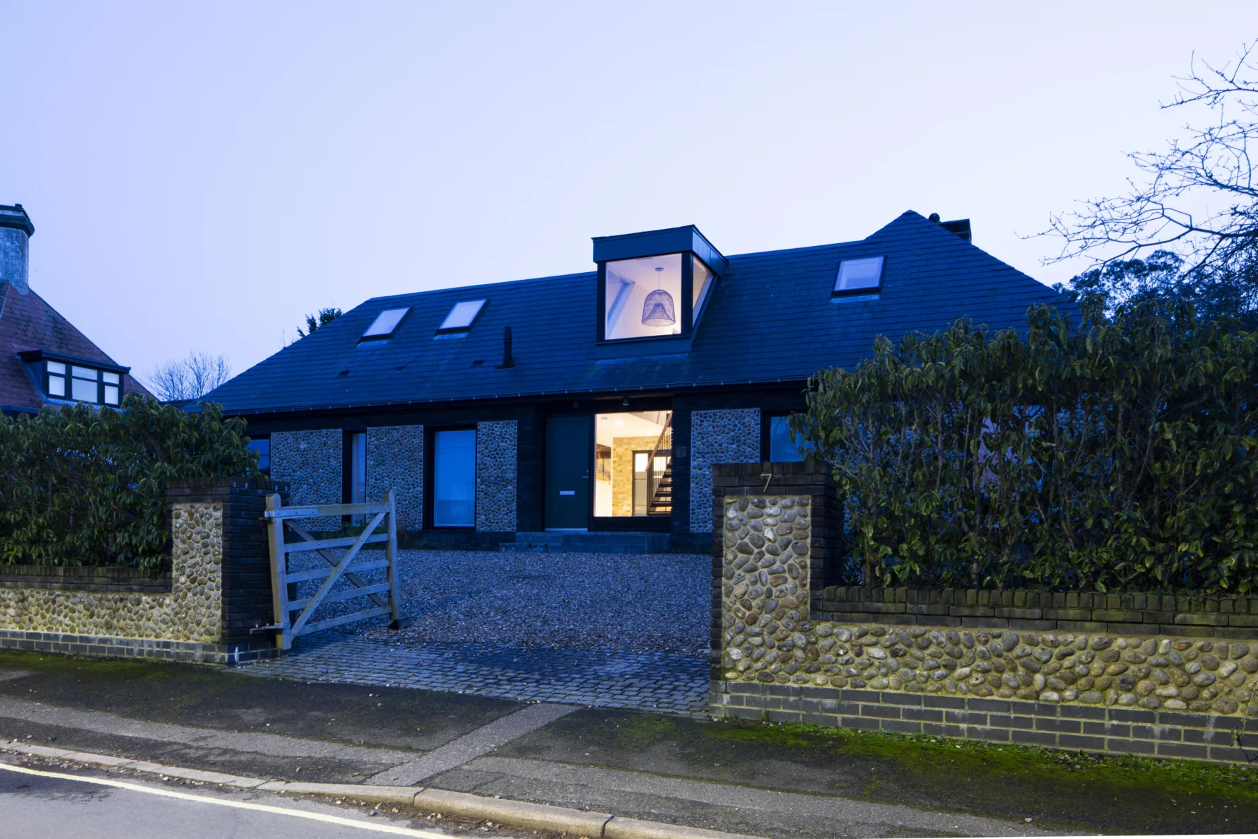 Contemporary renovated house with loft conversion and zinc roof in Old Hunstanton street view at dusk