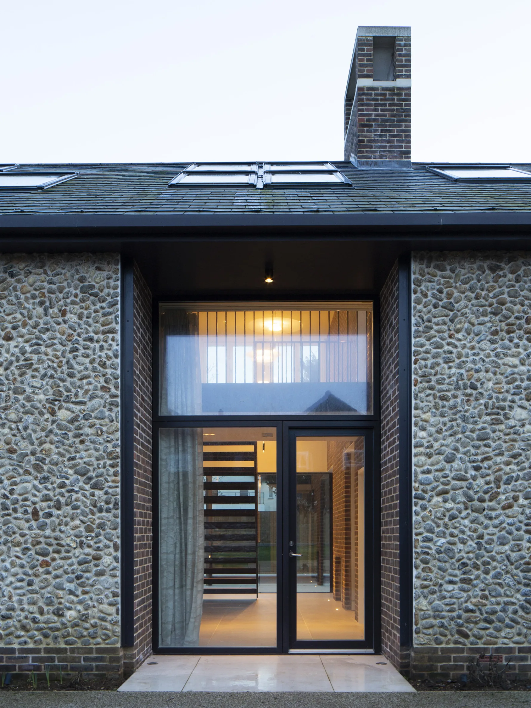 Contemporary new build house in Old Hunstanton with flint and brick facade and large glazed entrance