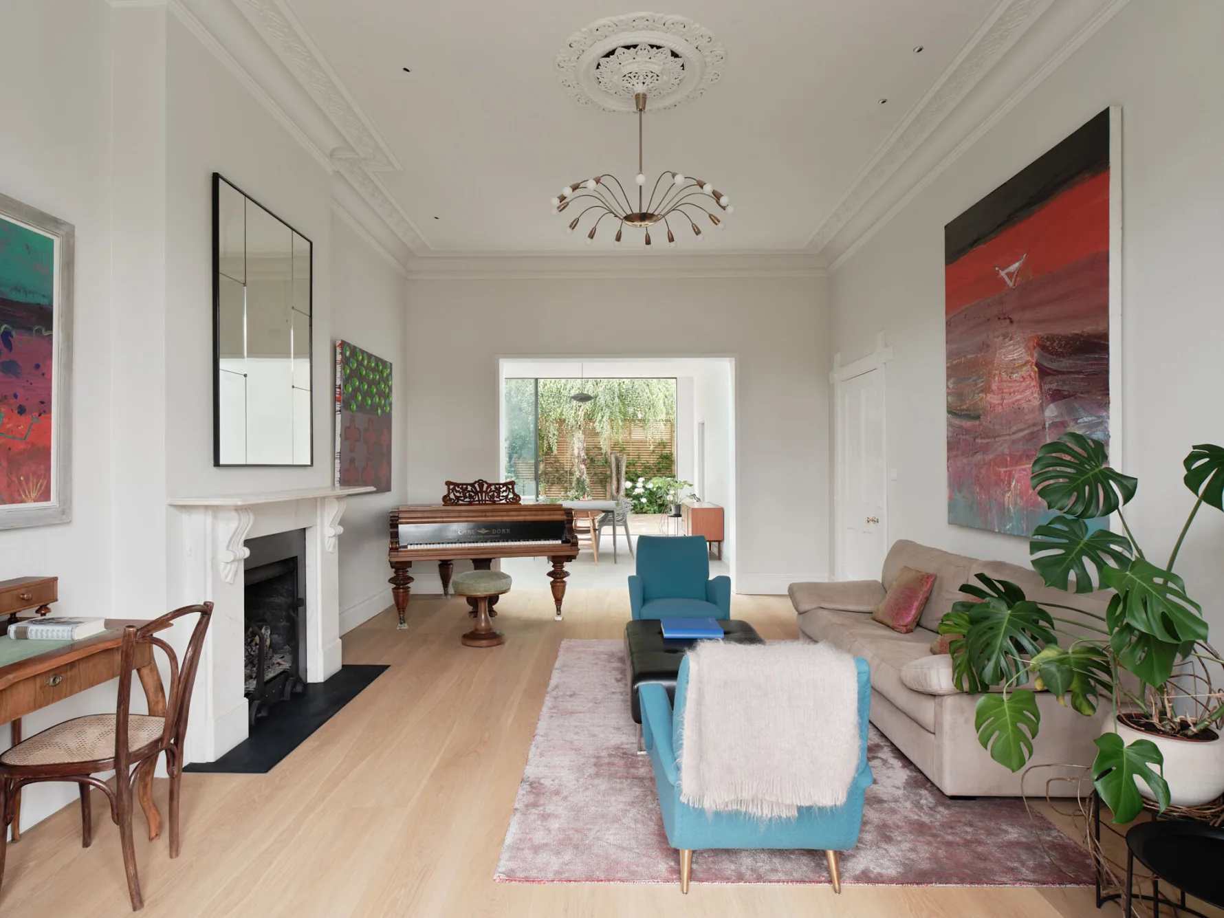 Elegant reception room with restored period features, contemporary furnishings, artwork and views through to the garden.