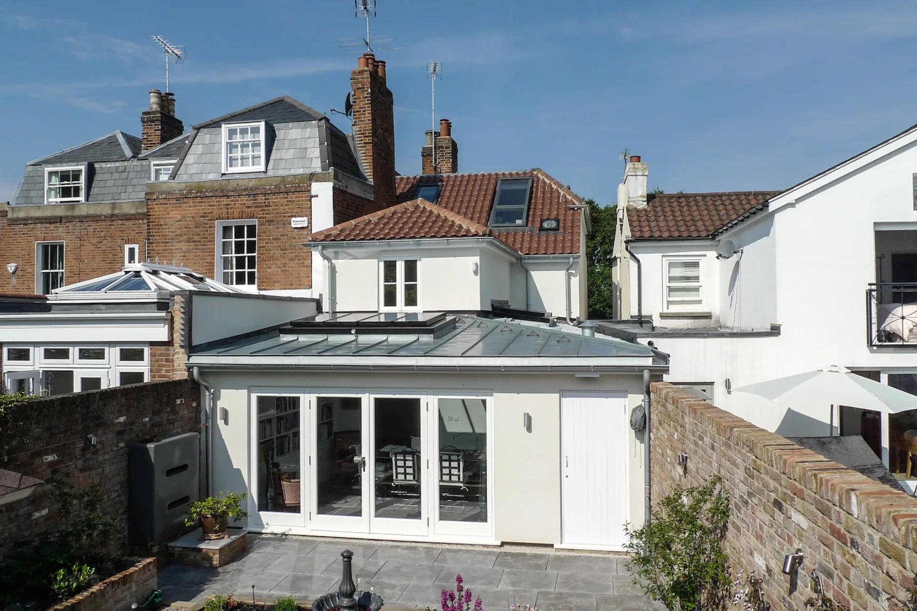 Contemporary rear extension to Thames Ditton House 04 featuring glazed doors, zinc rooflight and landscaped courtyard garden