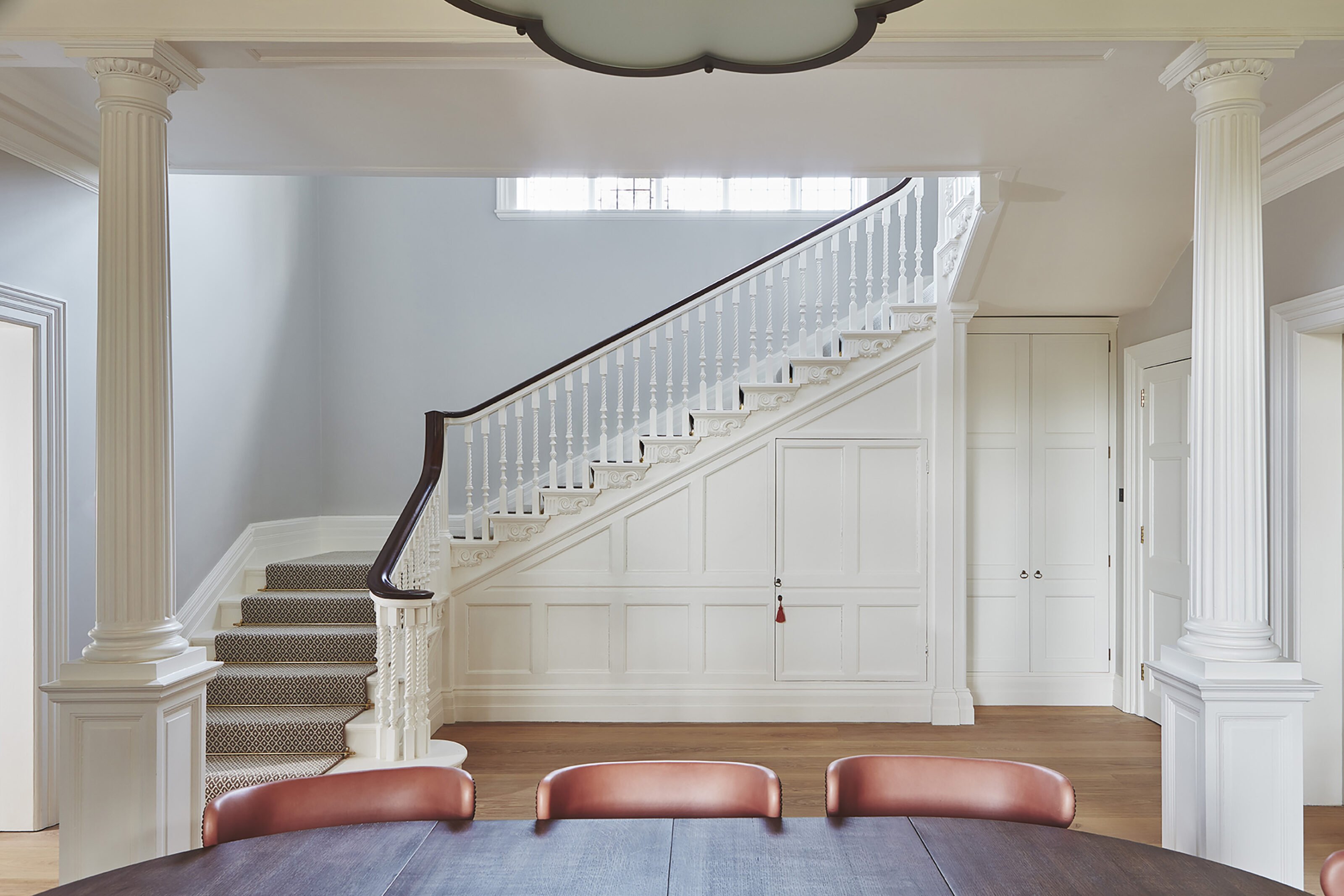 Restored Edwardian staircase hall with original architectural detailing and contemporary interior finishes at Westerham House.