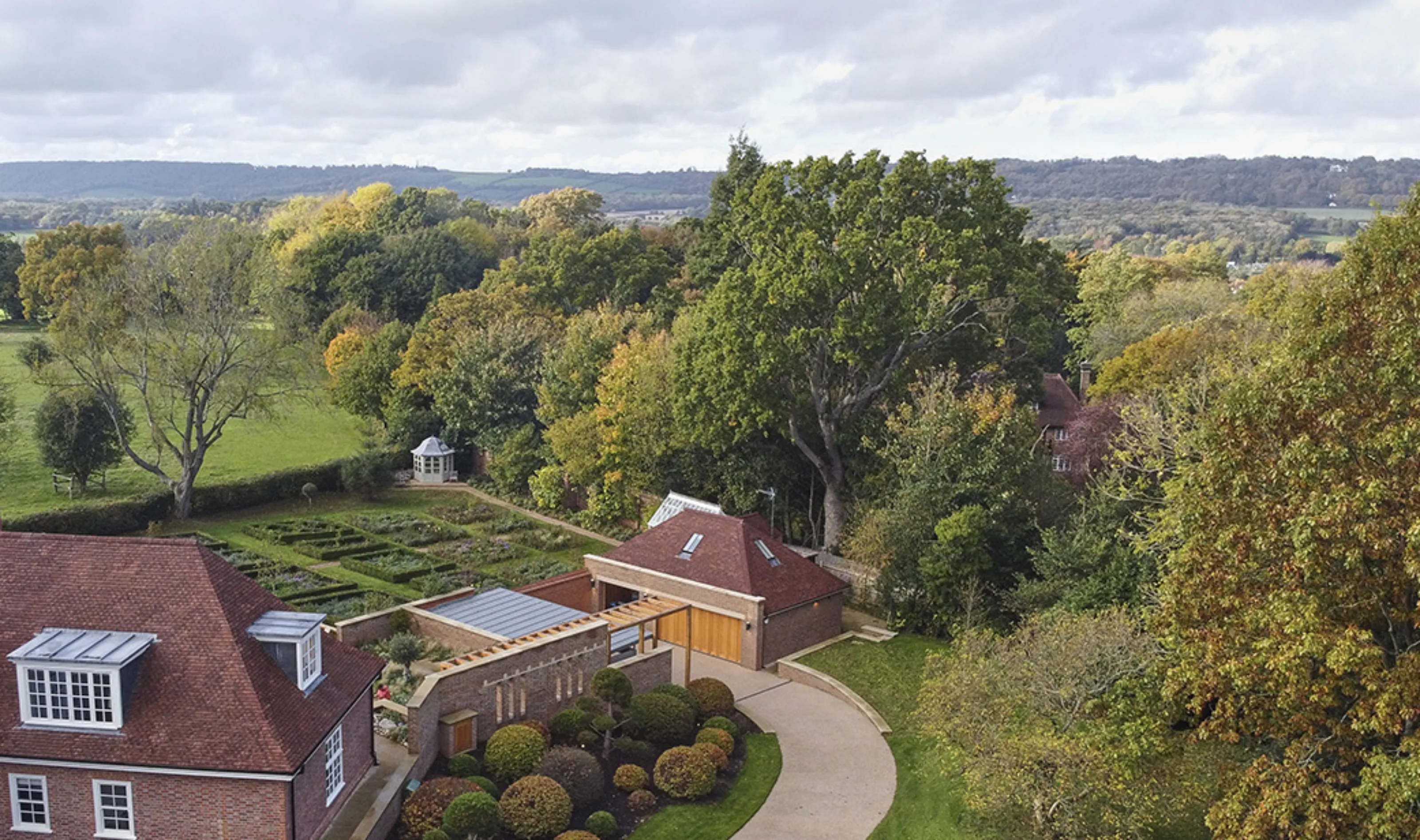 Aerial view of Westerham House showing the new extension, restored walled garden and landscaped grounds within the Kent Downs.