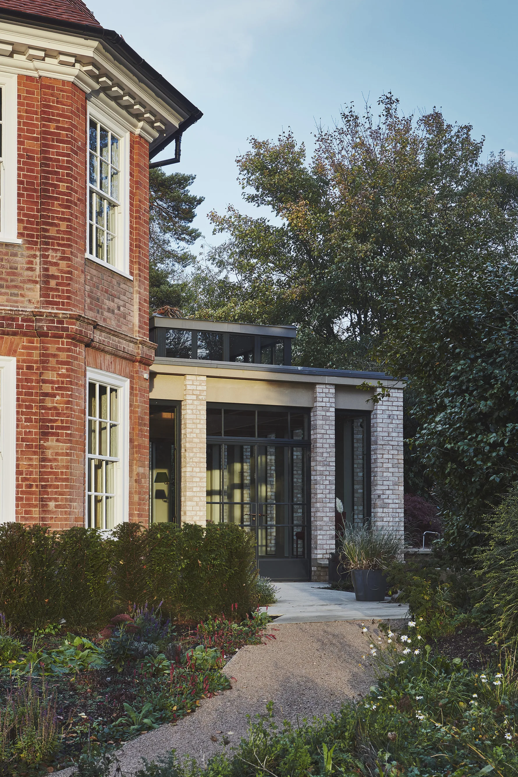 Contemporary pale brick garden room extension connecting to the original Edwardian house at Westerham House.