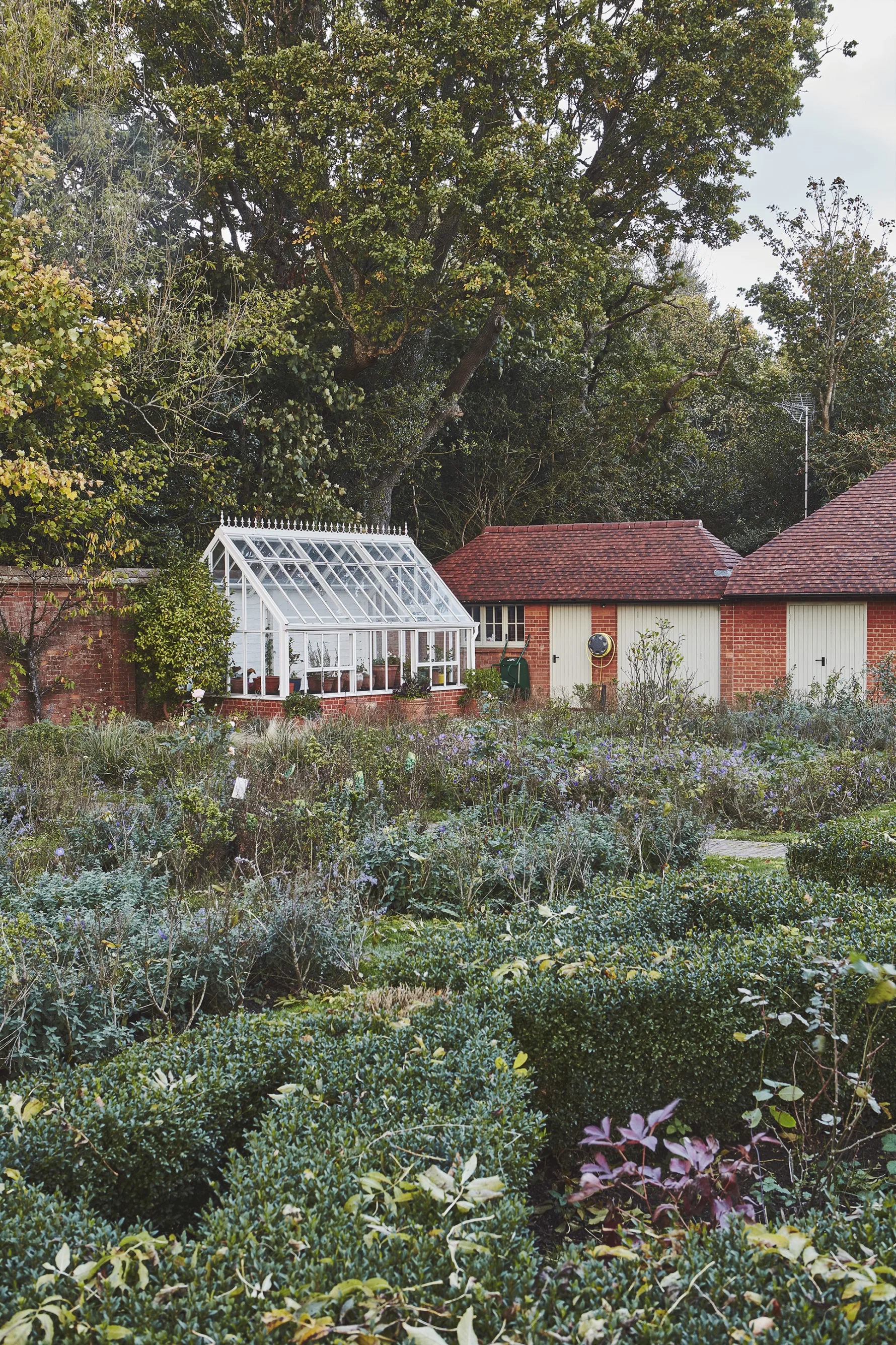 Restored walled garden with traditional greenhouse and productive planting at Westerham House.