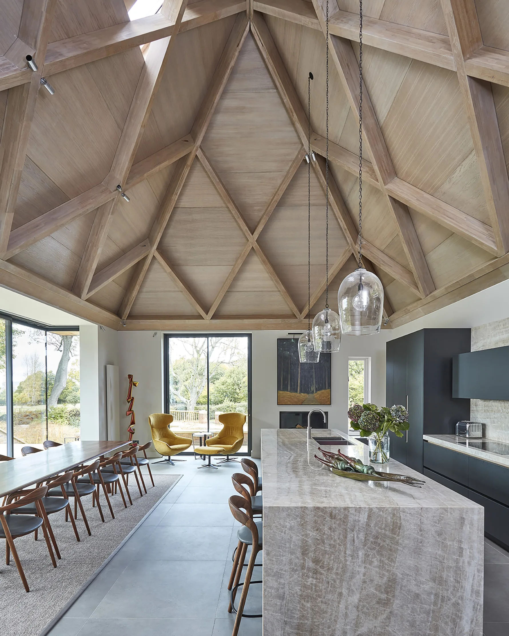 Contemporary kitchen extension beneath a vaulted oak ceiling at Westerham House, combining modern design with natural materials.