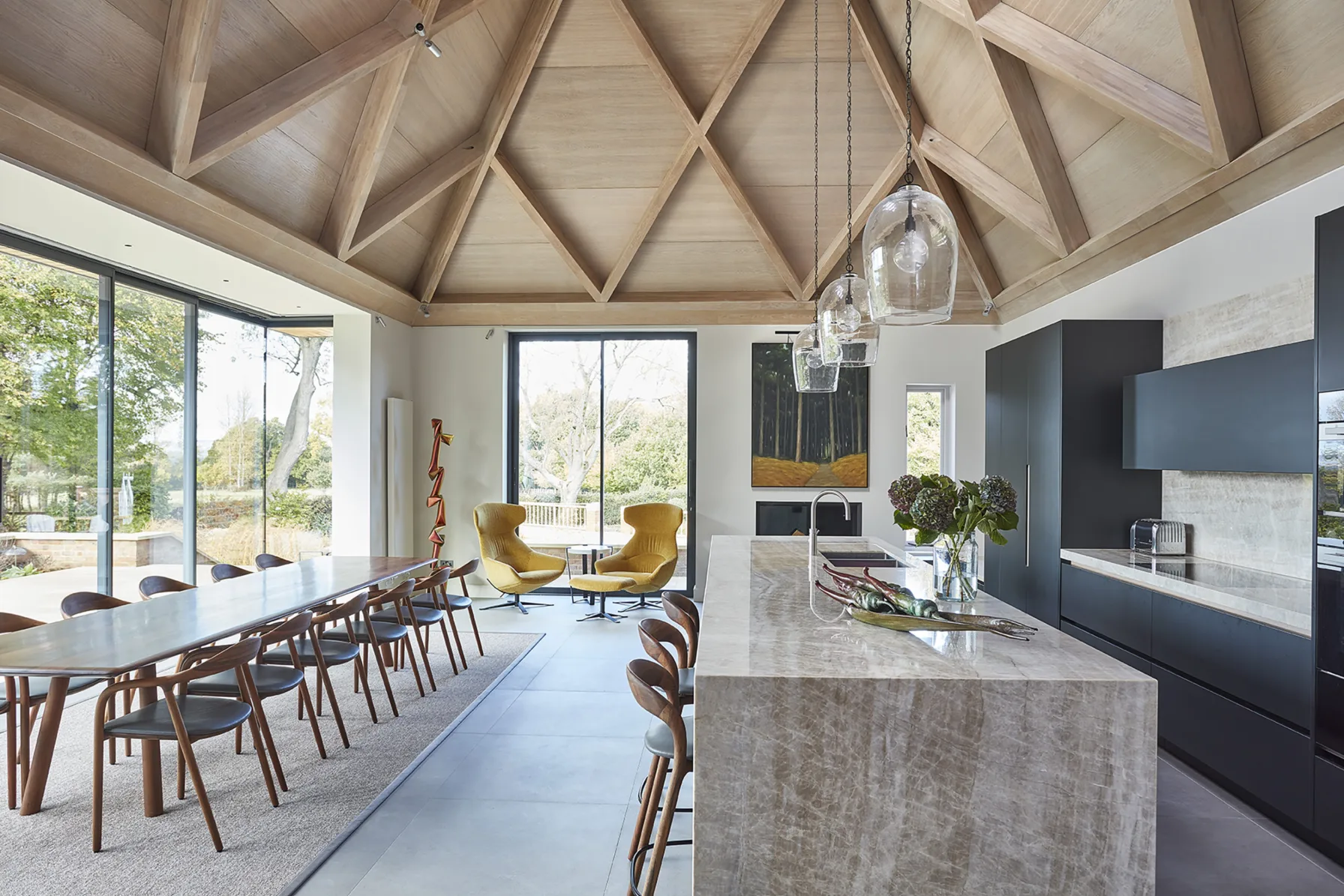 Kitchen and dining extension at Westerham House with a vaulted oak ceiling, contemporary kitchen island and panoramic garden views.