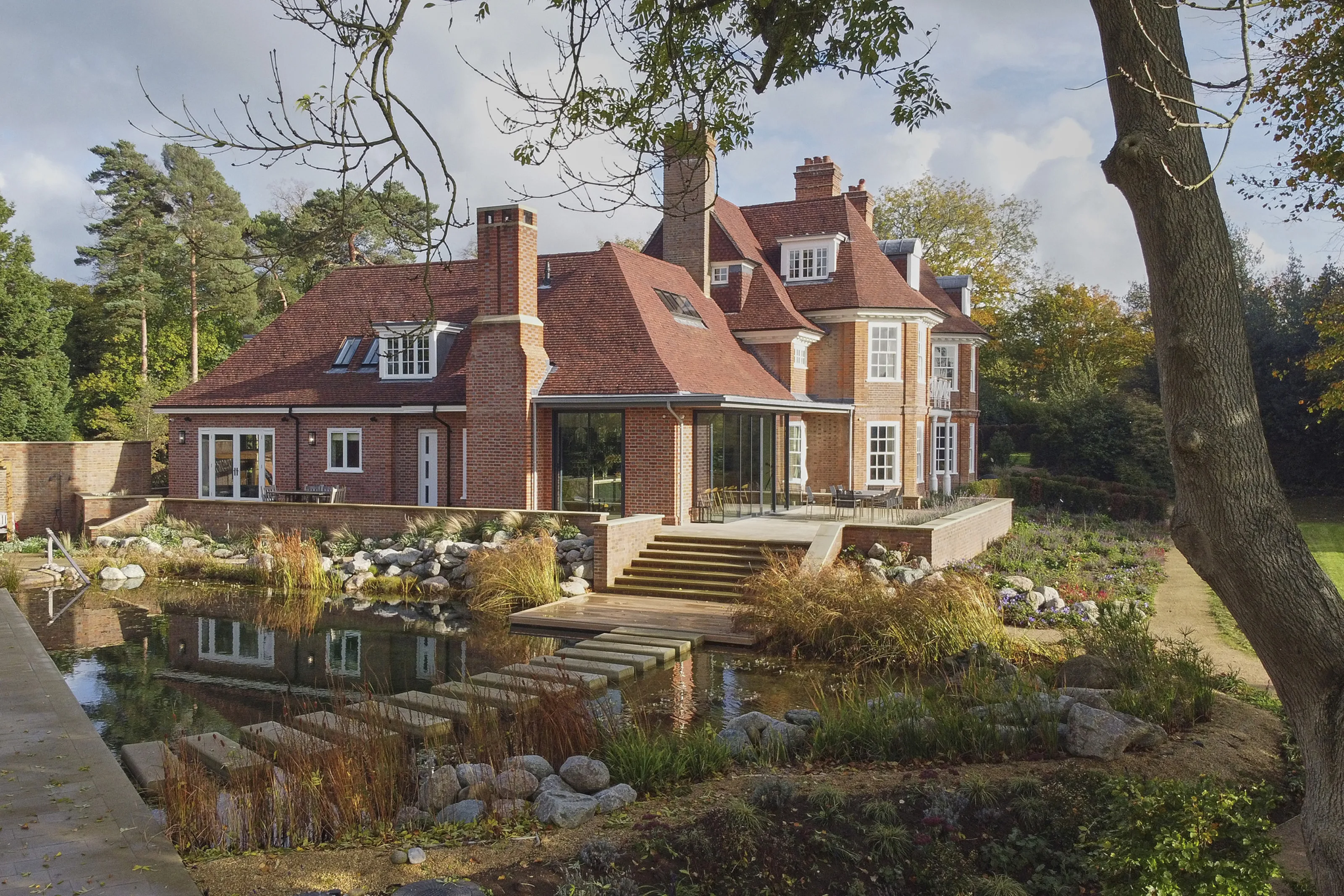 Contemporary renovation of Edwardian country house with swimming pond and restored garden in the Kent Downs
